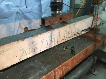 Cracking pattern and peeling off of CFRP at failure for beam B-N-2-4.