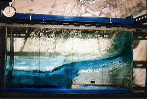 Collapse of a water column over a rigid step. Velocity contours over the deformed configuration at time: t=0.1s, 0.2s, t=0.3s and 0.4s. Results obtained with the finest mesh and slip conditions on the walls.