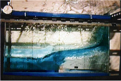 Collapse of a water column over a rigid step. Velocity contours over the deformed configuration at time: t=0.1s, 0.2s, t=0.3s and 0.4s. Results obtained with the finest mesh and slip conditions on the walls.